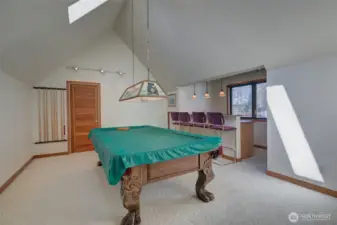 ABOVE ONE OF THE GARAGES IS AN APARTMENT. CURRENTLY THERE IS A POOL TABLE IN THE LIVING ROOM!