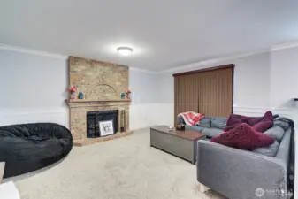 Cozy wood fireplace graces the family room with access to rear deck