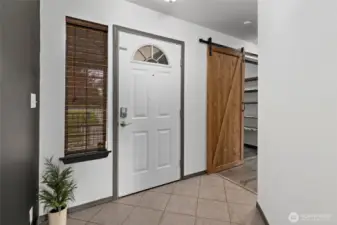 Front door into entry way. Barn door into laundry room.