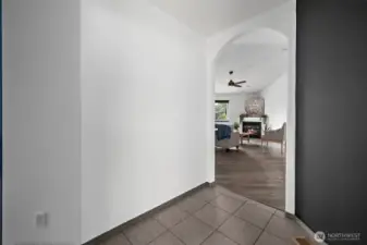 Tiled in entry way with view into living room.