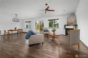 Vaulted ceilings, ceiling fan, and beautiful new light fixtures make this a very inviting living space.
