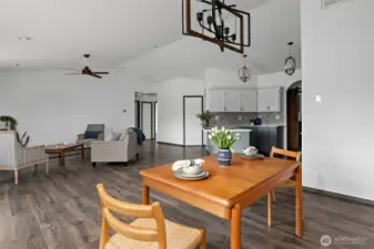 Dining area with beautiful updated light fixture.