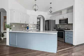 Beautiful light fixtures add a luxury feel to the updated kitchen.
