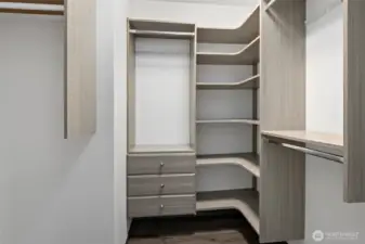 Walk in closet in primary bedroom is well organized.