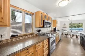 Updated kitchen offers lots of cabinet space, quartz countertops, stainless steel appliances- all with a view of the lake.