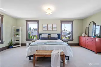 Upstairs, the Primary Bedroom is the crown jewel. Spanning the length of the home, this bedroom is spacious and bright.