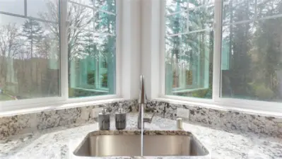 Kitchen sink looks out towards the front yard