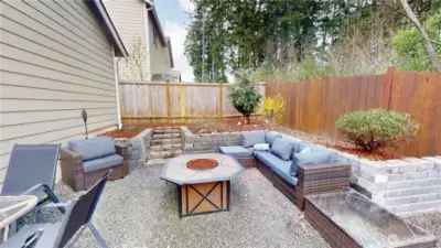 Dedicated fire pit space with gravel