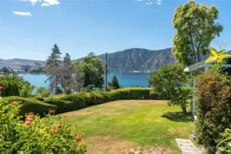 Lush, professionally landscaped yard with vibrant seasonal blooms, mature trees, and manicured lawn — a serene outdoor retreat perfect for entertaining, play, or peaceful relaxation.