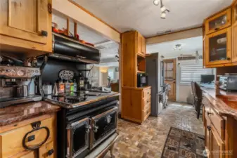 A charming vintage stove adds timeless character and a touch of nostalgia to this thoughtfully designed kitchen.