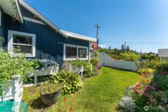 A pristine, manicured yard adorned with stunning seasonal flowers, enhancing curb appeal and outdoor enjoyment.