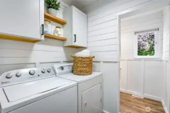 Newly updated laundry room with 1/2 bath and utility sink.