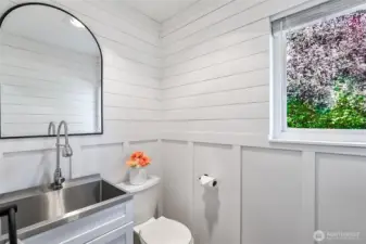 Downstairs half bath with utility sink.