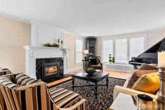 The formal living room is centered around a marble slab gas fireplace.