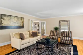 Handcrafted French doors provide a refined transition between living spaces.