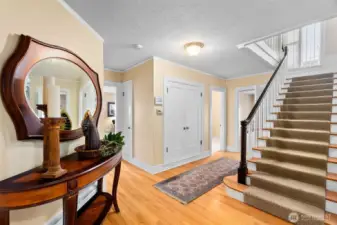 A transitional space that connects access to all areas of the home. The large closet is much bigger than you'd expect, plus an additional coat closet outside the casual living room. A view of the 1/2 bathroom and access to the lower level.