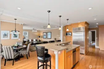 The island is the focal point of the kitchen. With space to cook, gather, and enjoy meals together. The prep sink features a disposal. The trash compactor in the center of the island is an added bonus.