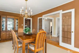 Entertain with ease - the dining room directly connects to the kitchen/wet bar area. Handcrafted French doors define the space.