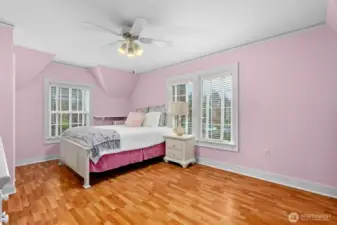 One of the five bedrooms upstairs. This room is extra spacious and drenched in natural light. The laminate floors are durable and easy to clean.