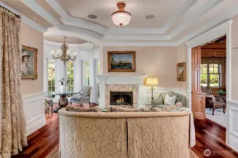 Formal living room. Attention to detail throughout. One of 7 gas fireplaces in the home. The turret section is perfect for a baby grand piano.