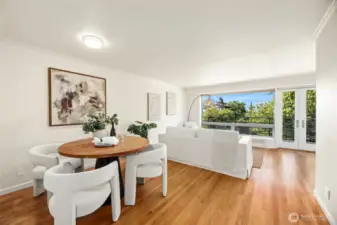 Drenched in natural Light the Living Room  and Dining Room  features real wood floors