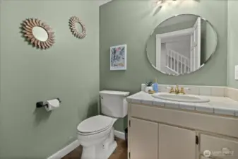1/2 bath located downstairs adjacent to dining/living room.