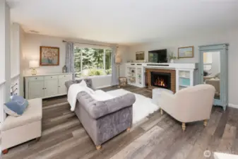 Newer LVP floors throughout. Warm wood-burning fireplace.
