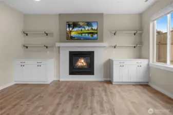 Gorgeous tiled gas fireplace with custom shelving and cupbords make an amazing focal point in this home.
