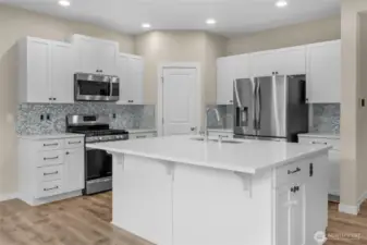 All stainless steel appliances make a beautiful contrast with the white accents!