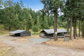 Your self-sufficient retreat in the woods—modern cabin, detached garage with 220 power, and plenty of space to grow.