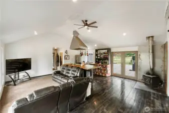 This cozy wood-burning stove adds a rustic charm and efficient warmth to the open living space, perfectly complementing the home's inviting atmosphere.