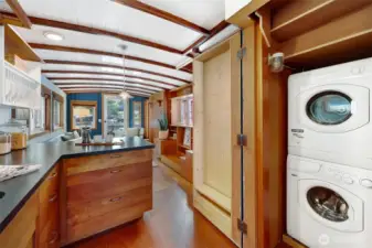 Deep closet to house the washer and dryer plus more shelving.