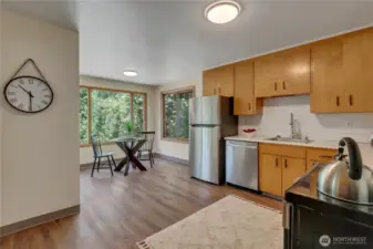 Kitchen to breakfast nook & slider to deck & backyard around left corner.