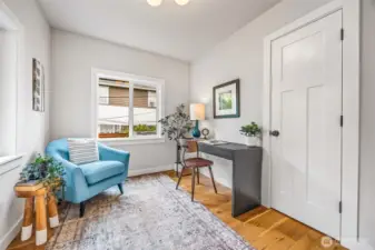 Sunny office space off main living area with closet for additional storage.