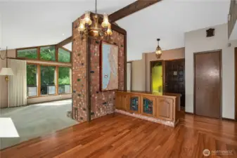 Entering into the home you will find the the dining room straight ahead and sunk in living room off to the right. The picture on the fireplace stays, there are 3 maps, hand painted, of the puget sound.