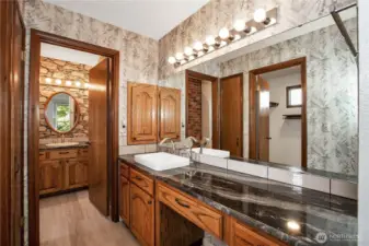 one of the bath sinks is separate from main portion of primary bathroom.