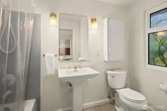 The primary Bathroom has custom stained glass windows.