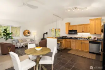 Home #2: Has a dining area, kitchen equipped with refrigerator, dishwasher, induction cooktop, microwave, sink and counter for barstools.