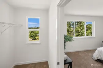 Primary walk-in closet with city views.