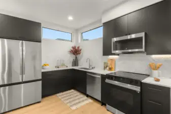 Samsung chef’s kitchen with sleek cabinetry, under-cab lighting, and contemporary hardware.