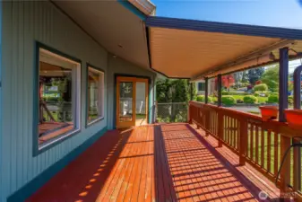 French doors open to the covered wrap around deck that faces the sunset and provides enjoyment in any weather.