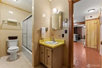 Retro-style main floor bathroom featuring a classic tub/shower combo and vintage tile accents—full of charm and character.