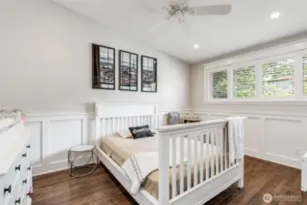 Second bedroom on the main floor with beautiful wainscoting, custom closet and shutters.