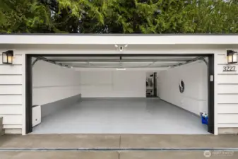 Spacious two car garage, new epoxy floors, glass garage door, Tesla charger and a wonderful mud room drop off space before entering the house.