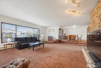 Main House: Spacious living room with wood-burning fireplace & wet bar with beautiful picture windows offering lots of natural light.
