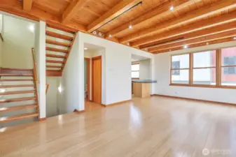 Light-filled and airy interior design with spacious living areas.  Beautiful exposed wood beam ceiling and open, reclaimed wood staircase.