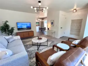 01 unit living room towards dining area and sliders to side yard