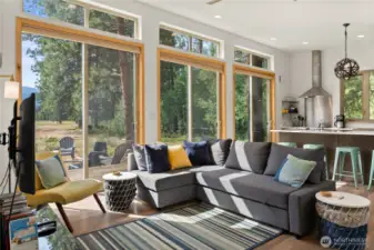 Open-concept living room filled with light and mountain views, perfect for relaxing or entertaining.