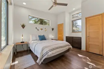 Primary bedroom retreat — Vaulted ceiling, modern fan, and private ensuite with abundant natural light.