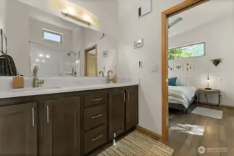 Stylish and functional – The main bath features a dual-sink vanity, modern fixtures, and direct access to the bedroom—perfect for effortless everyday living.